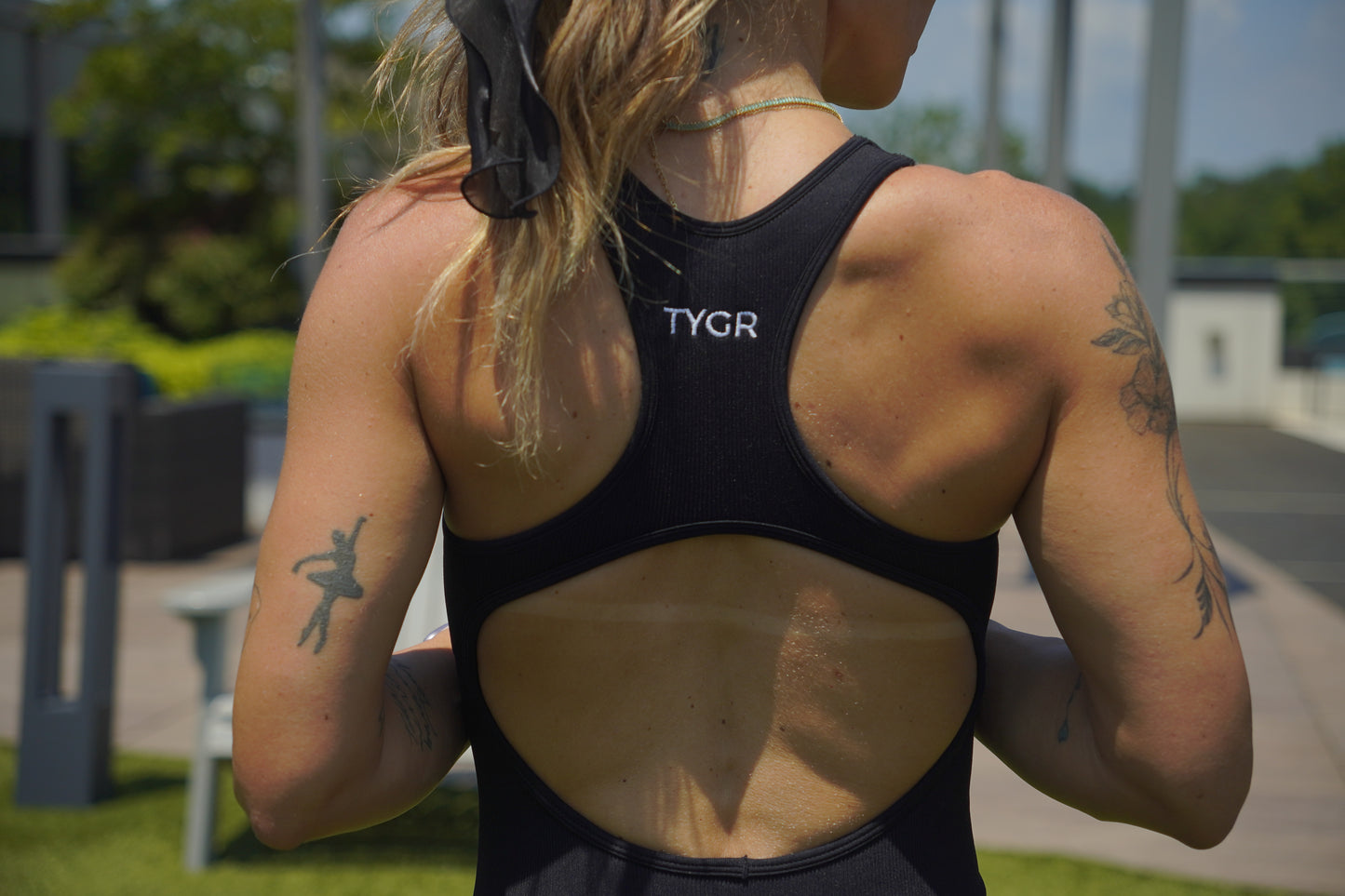 Person wearing a black TYGR jumpsuit outdoors